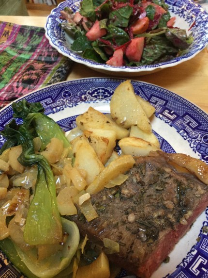 Steak with sauted bok choy and potatoes